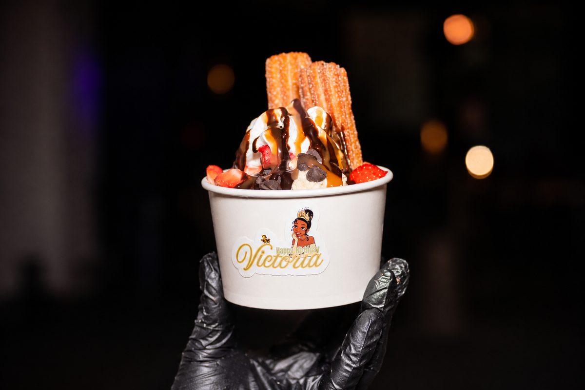 Churro sundae with ice cream, chocolate drizzle and fresh strawberries