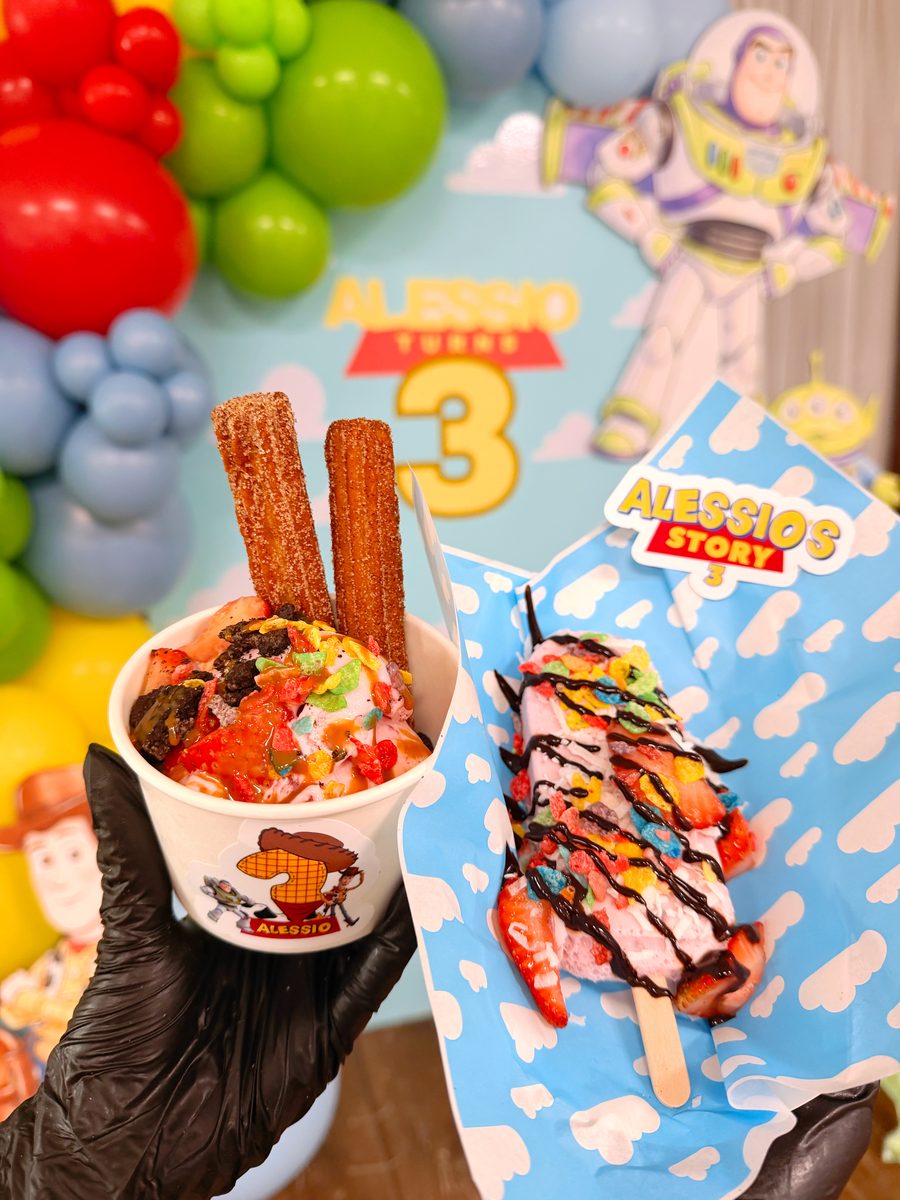 Golden churros served over ice cream with colorful toppings
